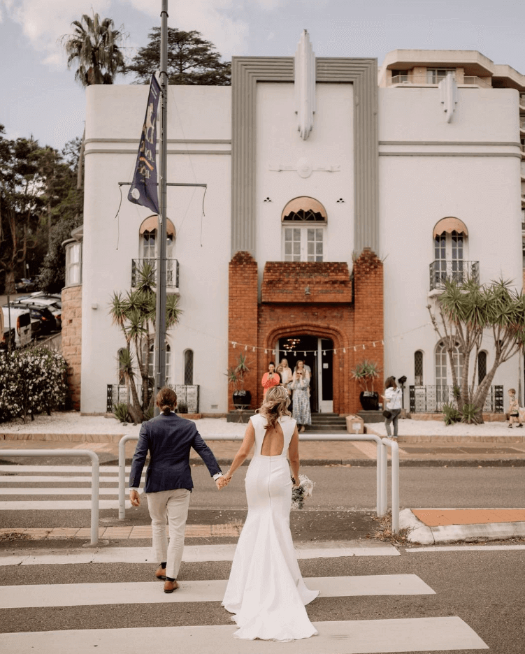 Wedding couple walking to Art Deco Chapel