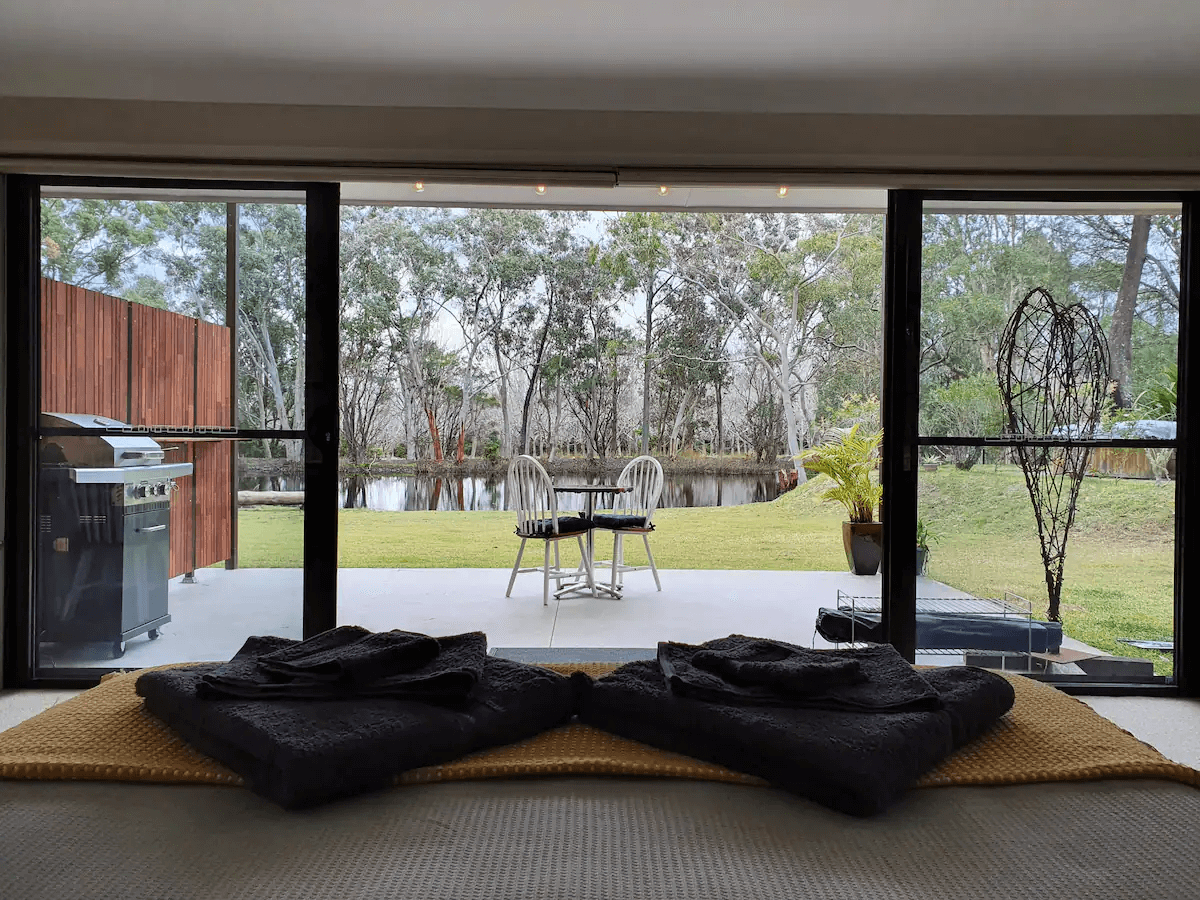 Looking outside from a cosy lounge room with two big cushions on the floor