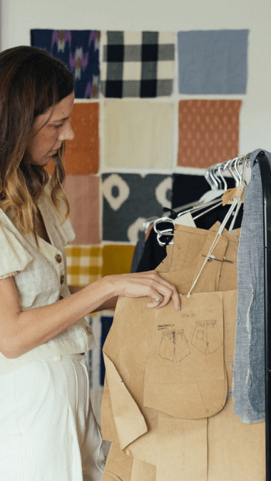 Woman looking at clothing patterns and materials