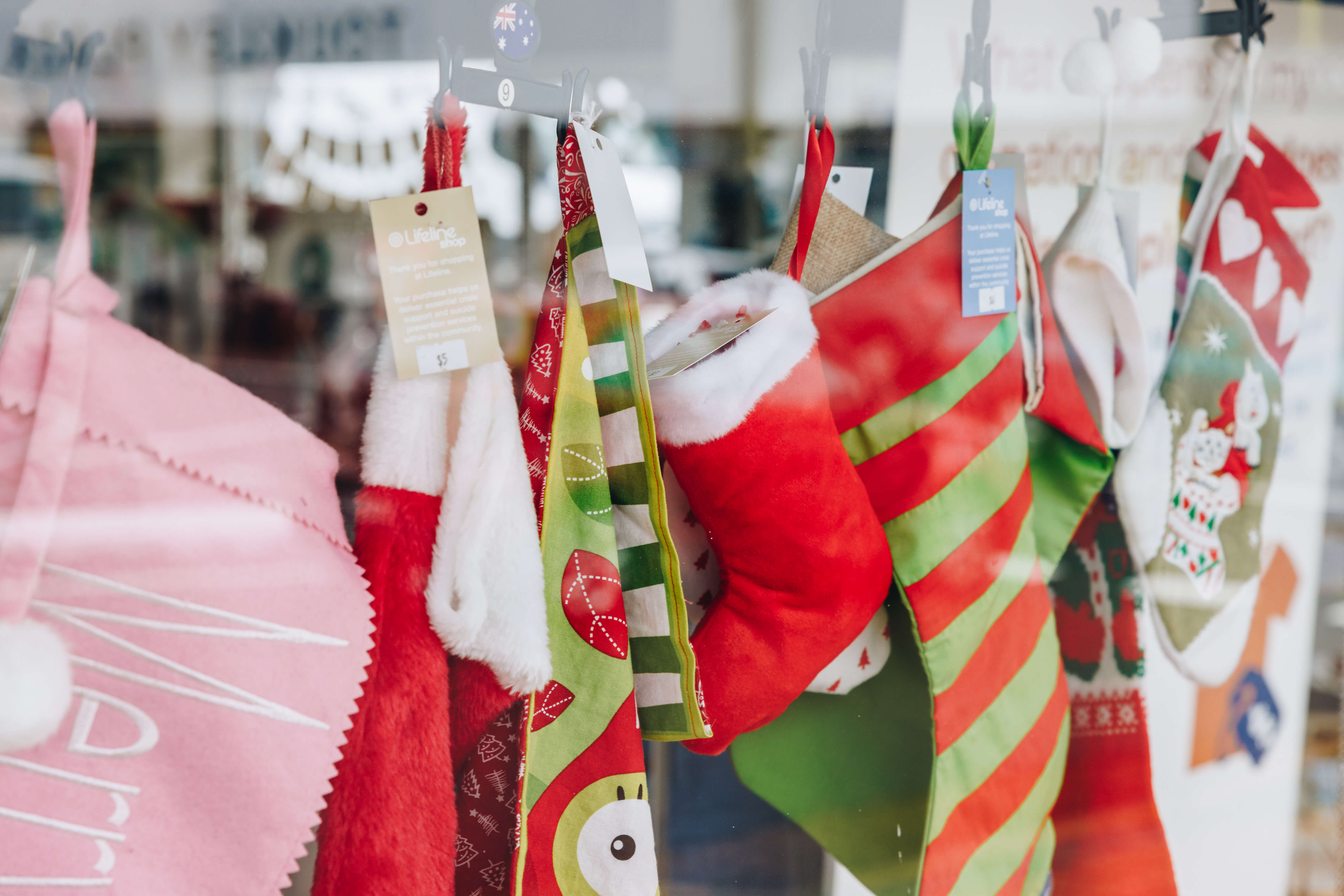 A window display of colourful stockings  hanging