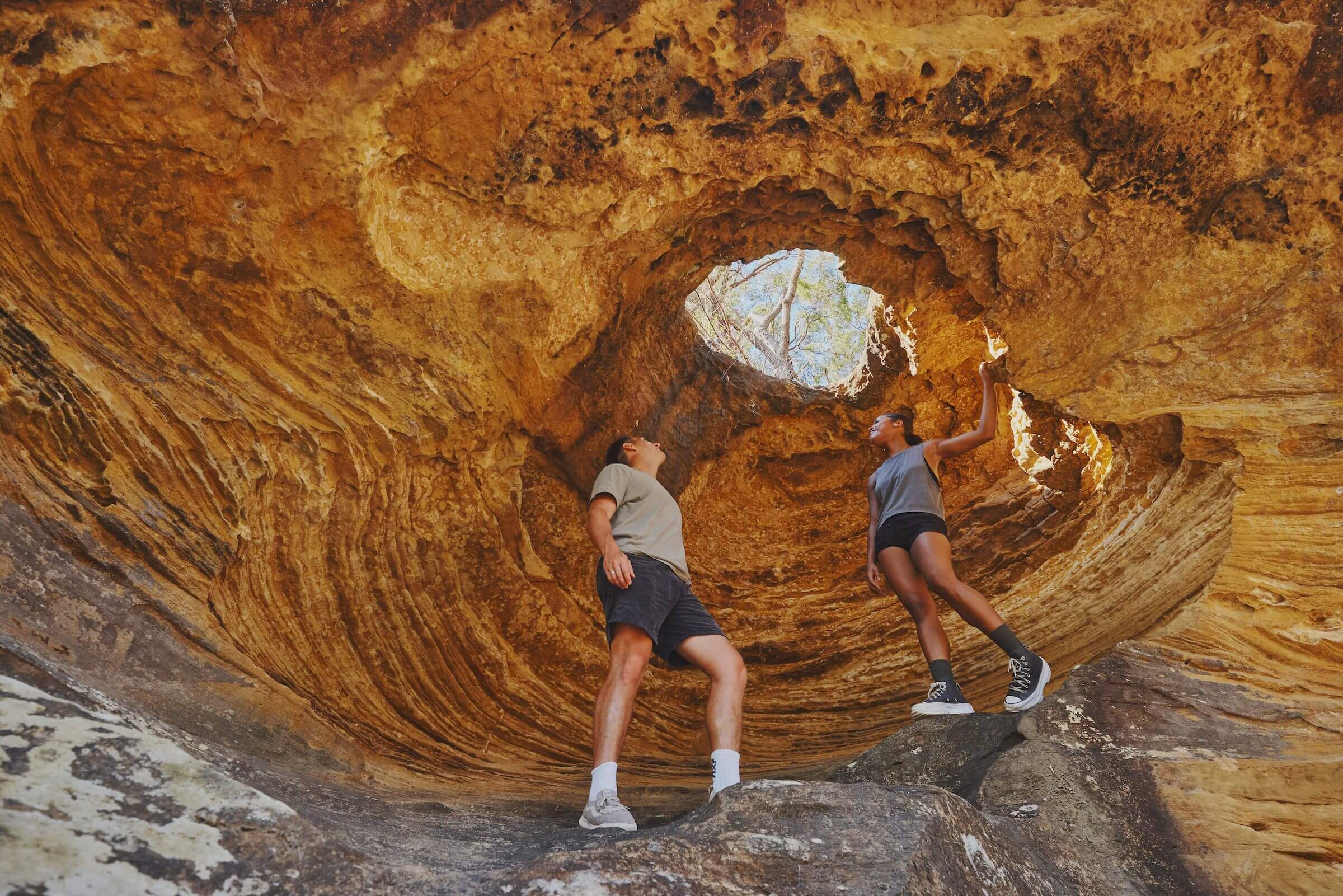 two hikers standing in hangmans rock which is a magnificent rock scultpure hollowed out