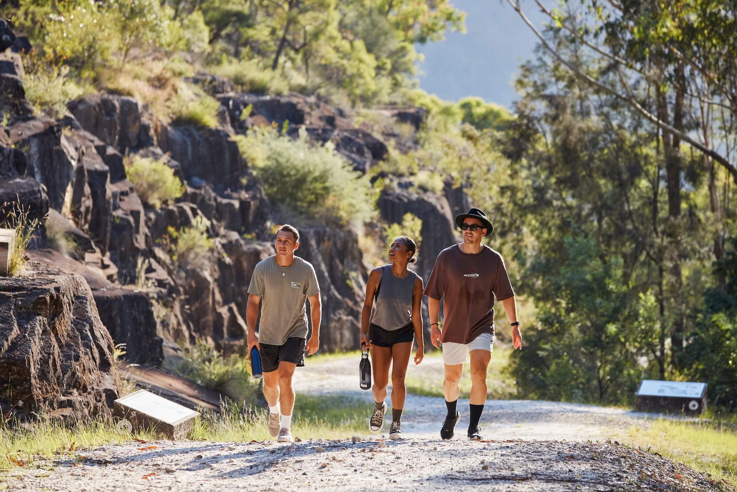 three people walking up the steep incline of devines hill