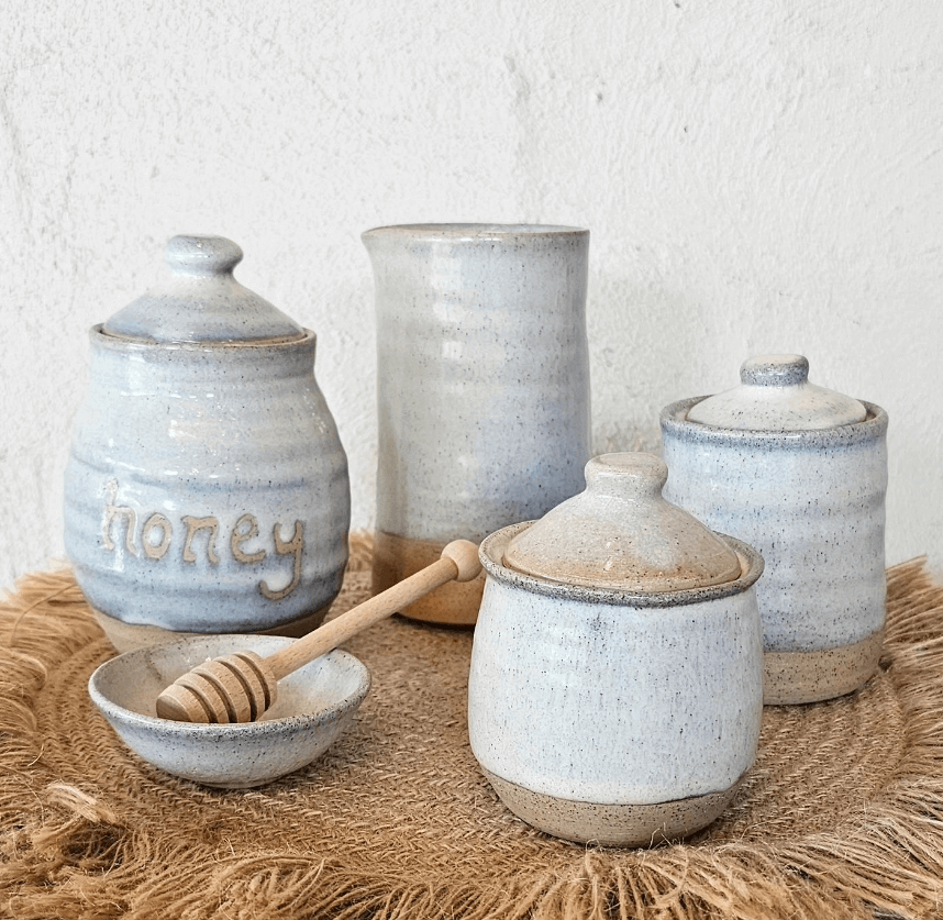 Stone earthware ceramics featuring a honey and storage jars