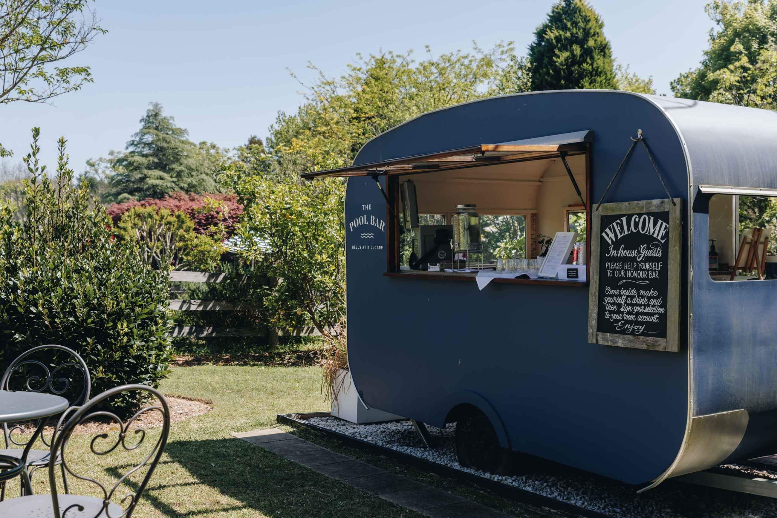 the pool bar trailer with its honesty system for guests to make their own fancy drink