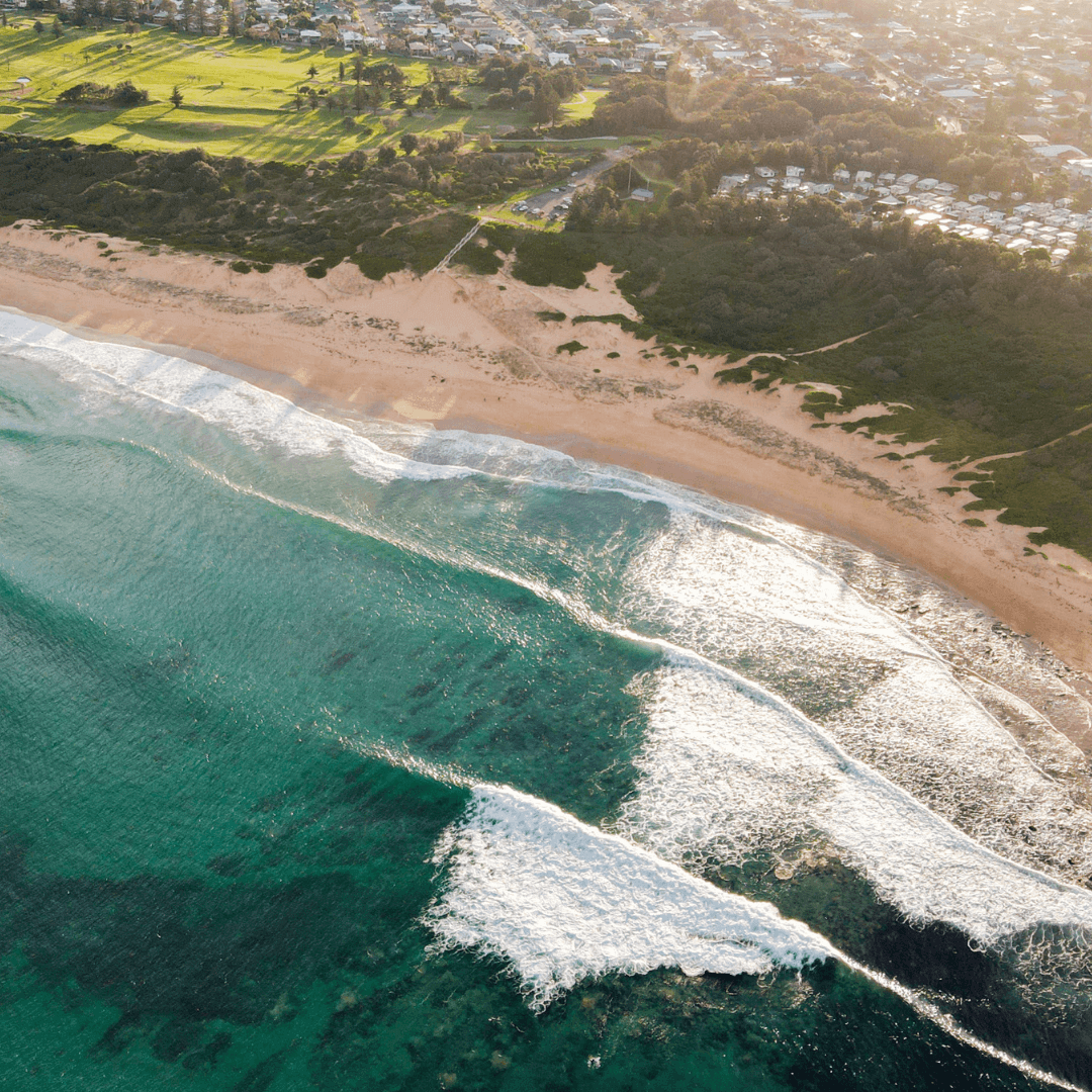 Aerial view of a coastal town featuring a beach