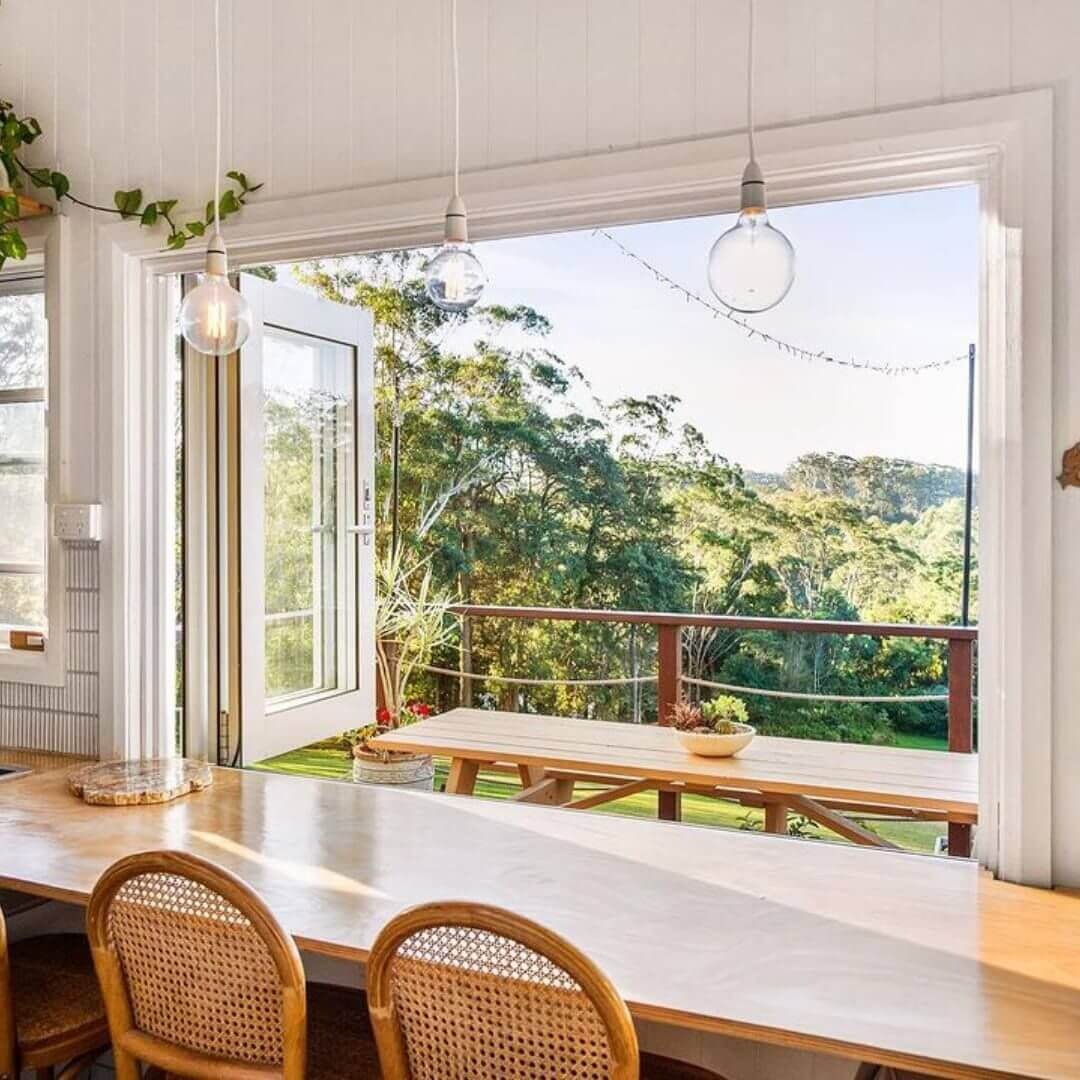 A breakfast bar with a view overlooking a valley.