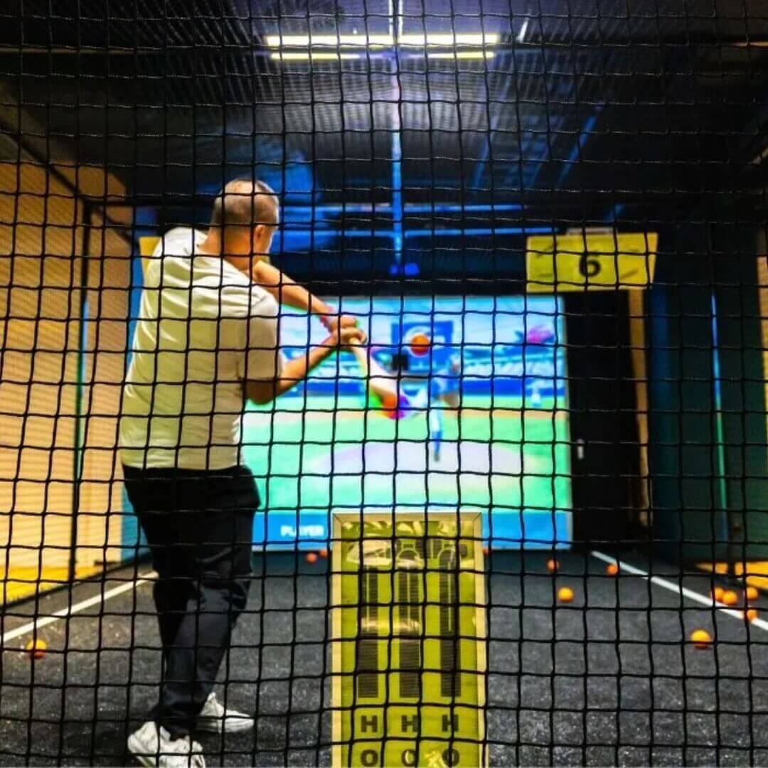 A man playing virtual cricket.