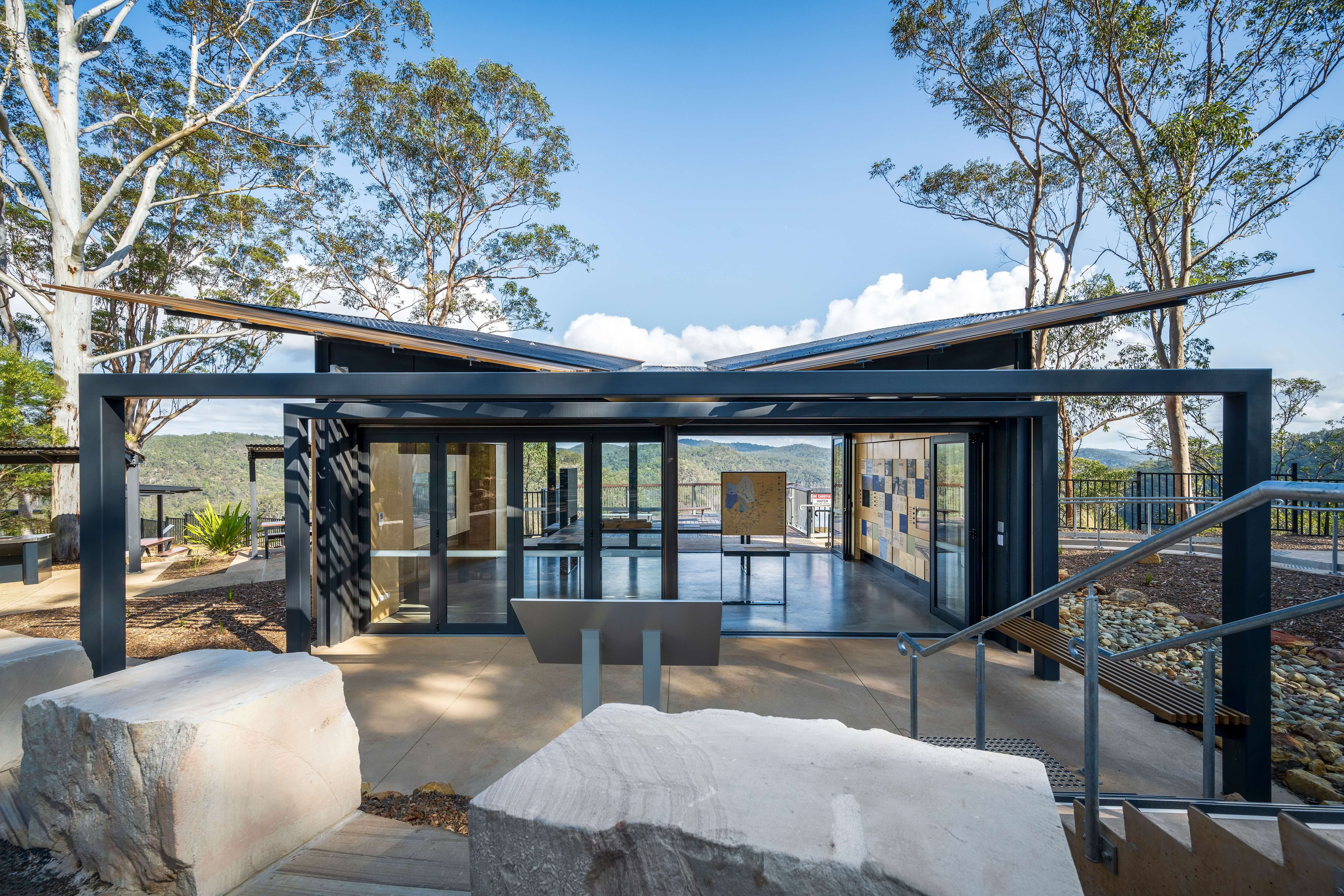 An architectural building sitting amongst bushland