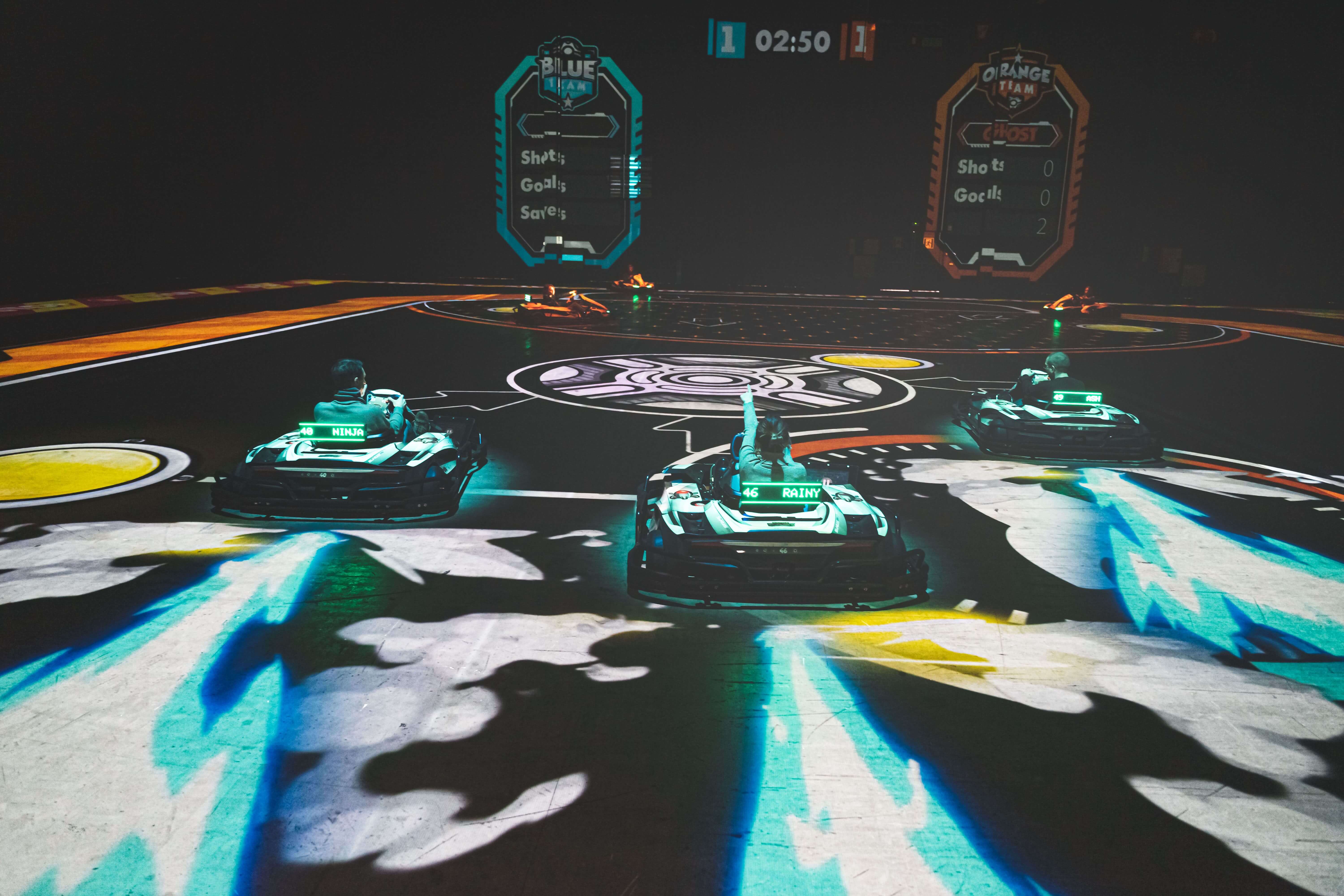 A vibrant neon-lit track with five electric karts 