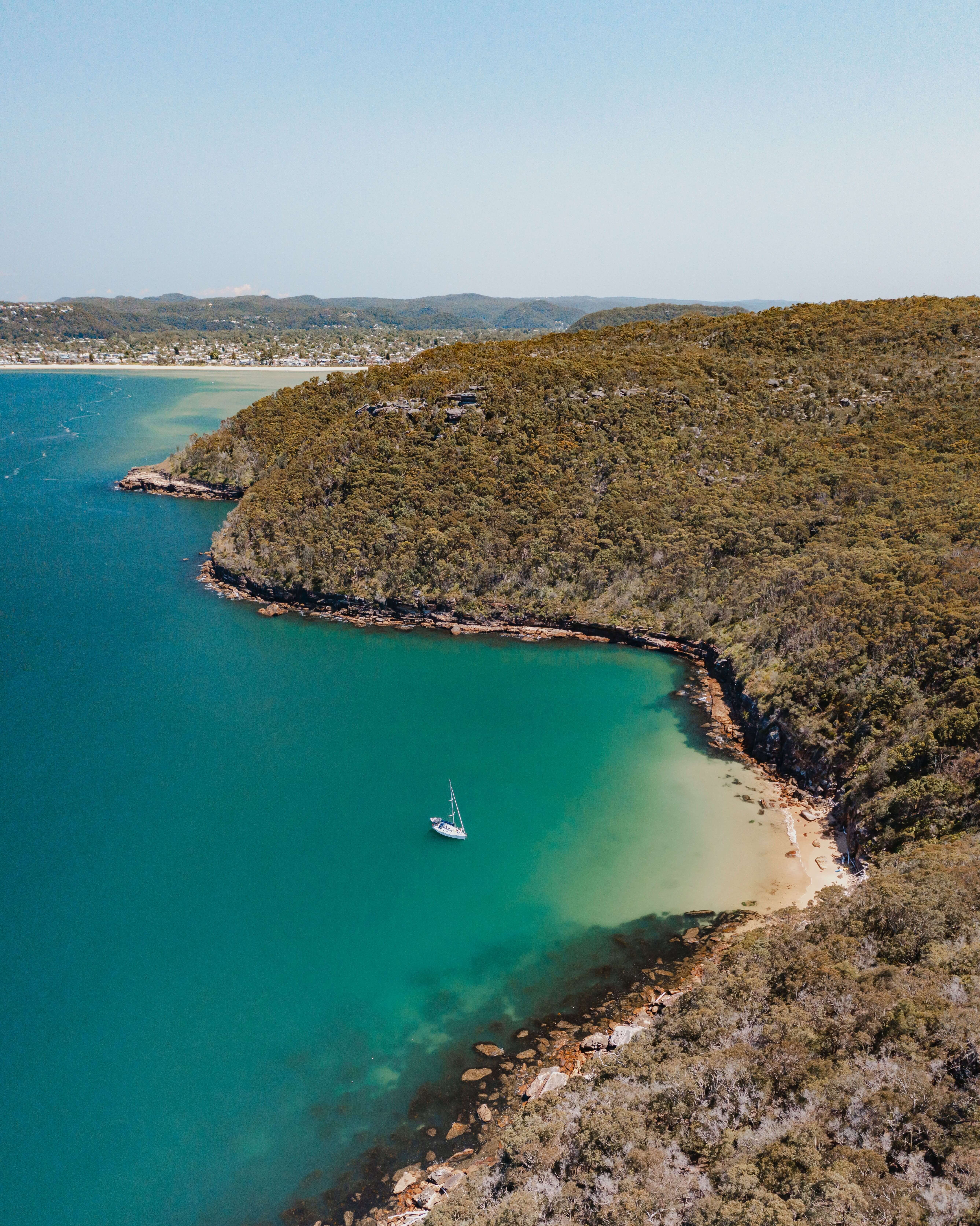 paradise like bay with sailing yacht afloat