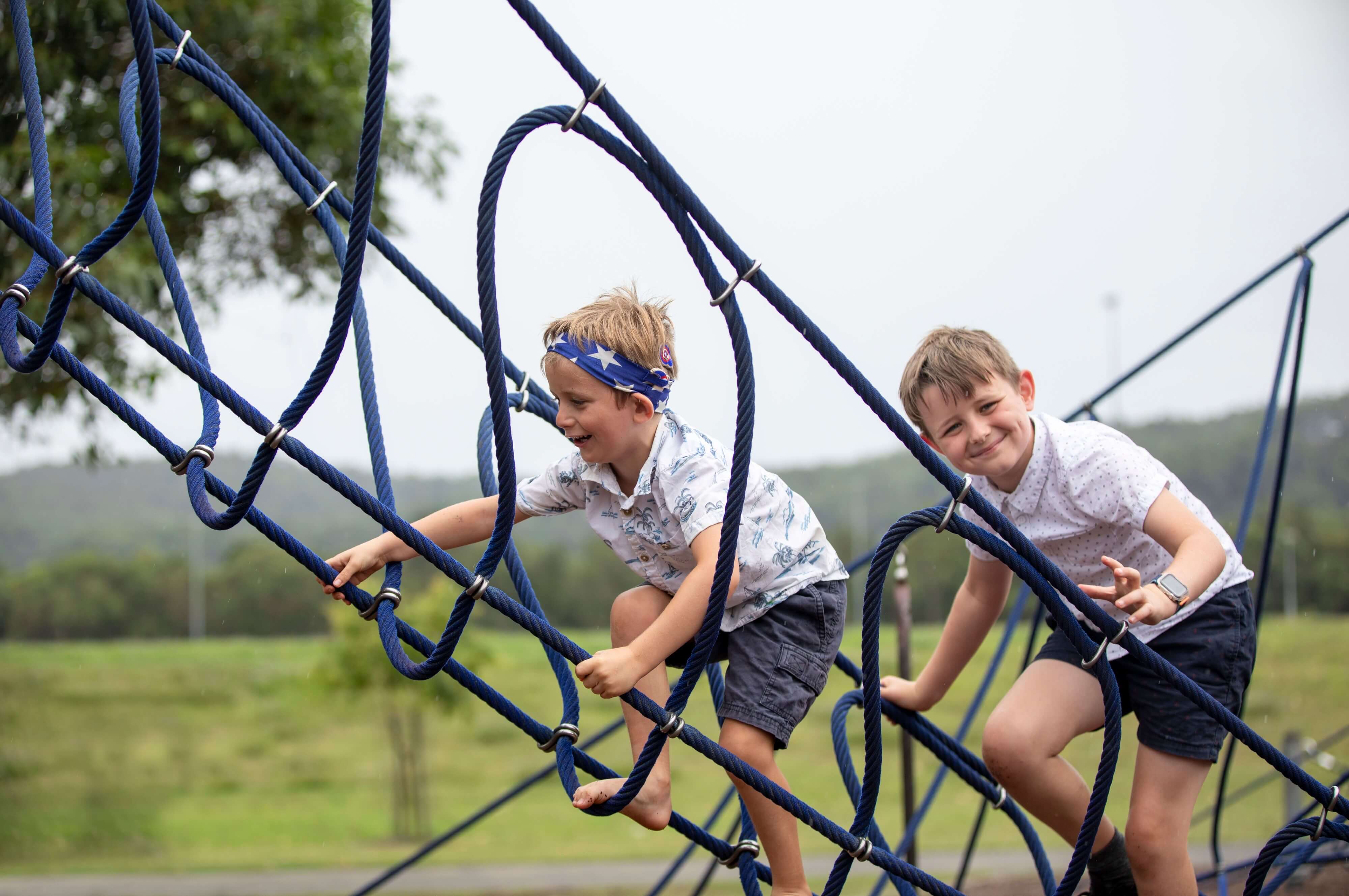 Two boys playing on equipment at Recreational Precinct playground