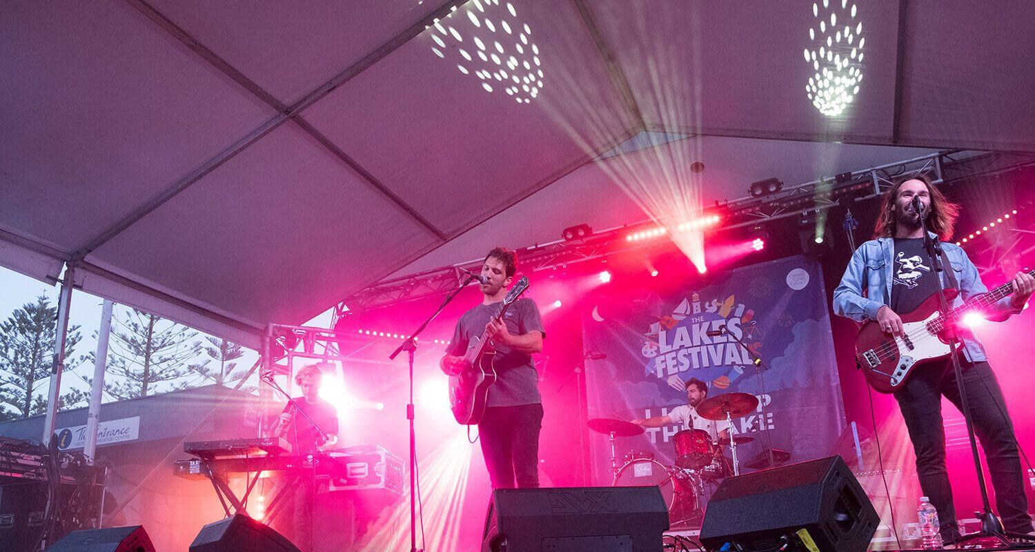 Band on stage with pink light