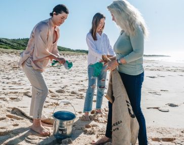 team of take 3 cleaning up a local beach of litter