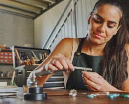 A focused woman meticulously crafting a beautiful piece of jewellery