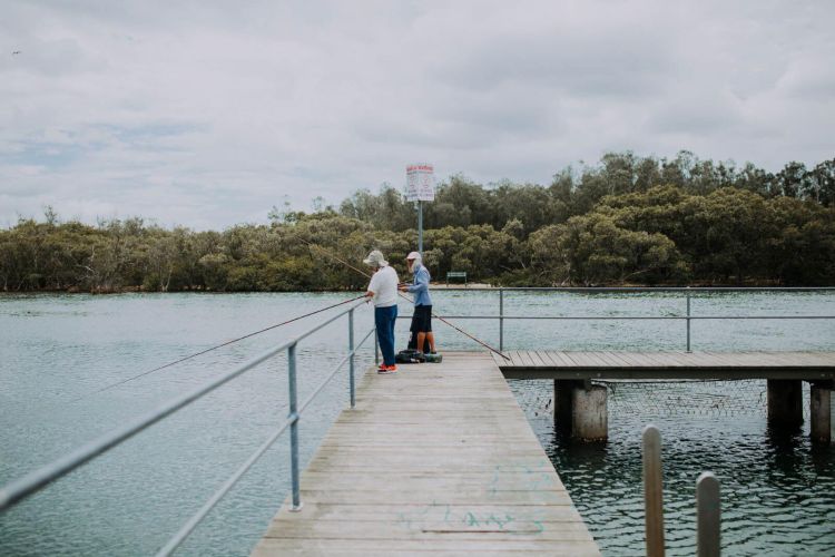 Two people standing on a wharf