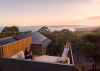 guests enjoy sunset on a lodge rooftop balcony with national park views